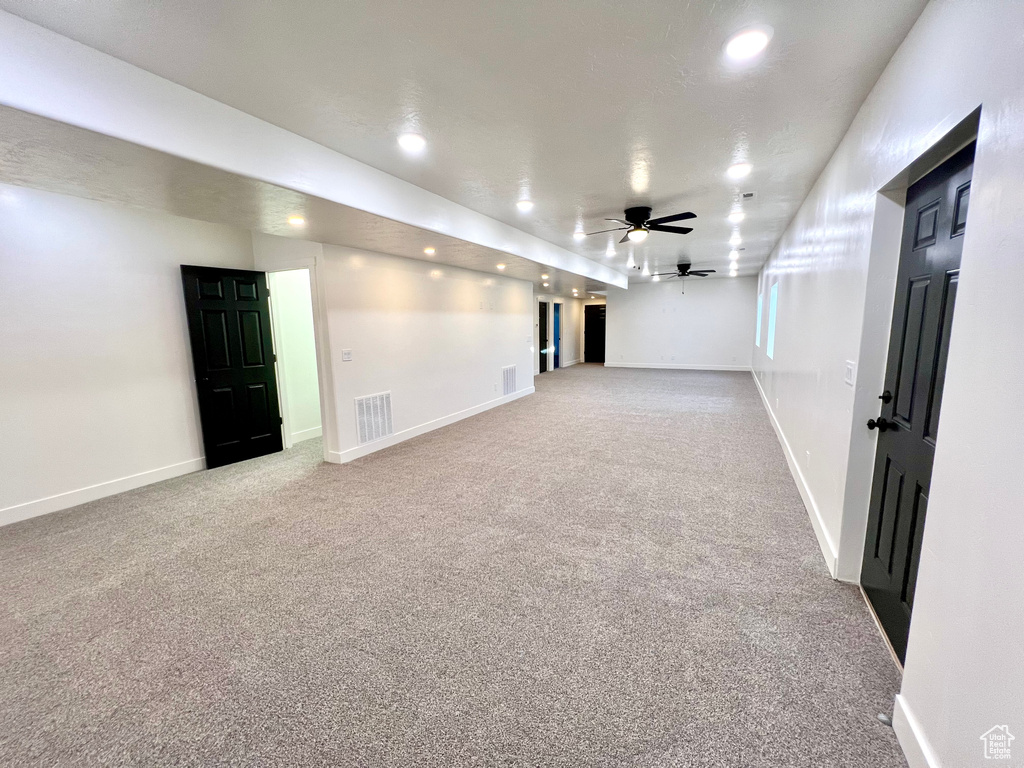 Carpeted empty room with ceiling fan