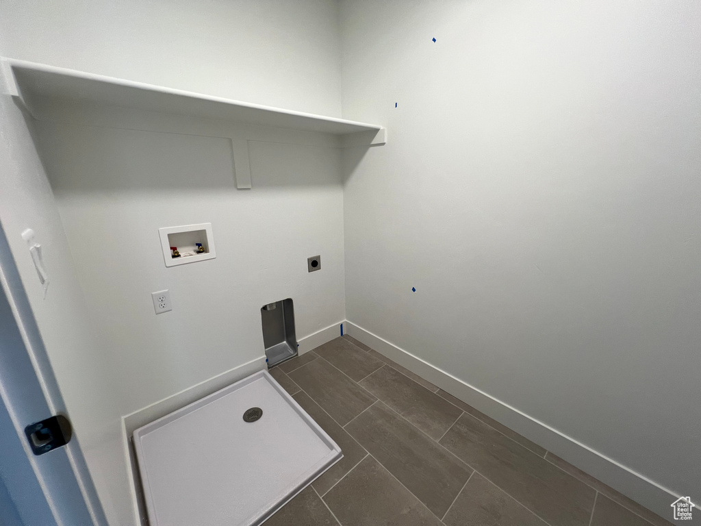Washroom featuring electric dryer hookup, laundry area, baseboards, and washer hookup