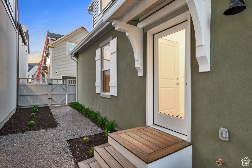 View of home's exterior with a gate and stucco siding