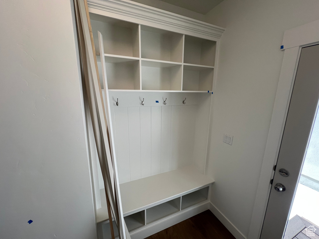 Mudroom featuring dark wood-style flooring and baseboards