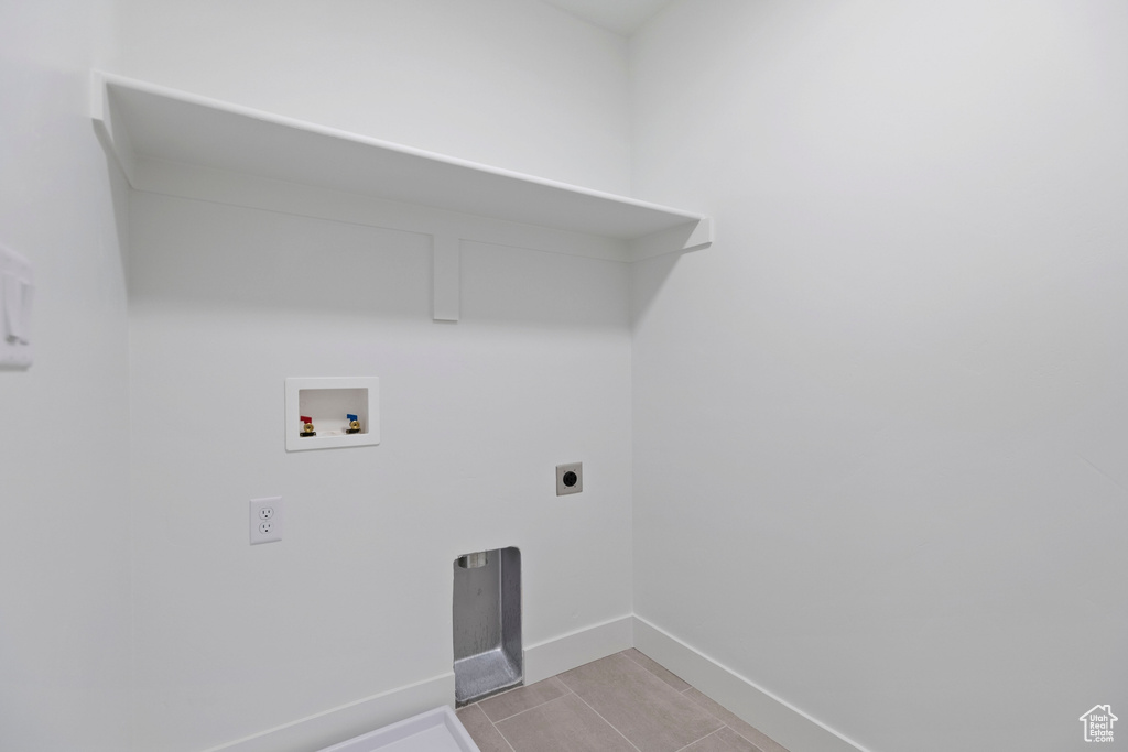 Clothes washing area with hookup for a washing machine, hookup for an electric dryer, and baseboards