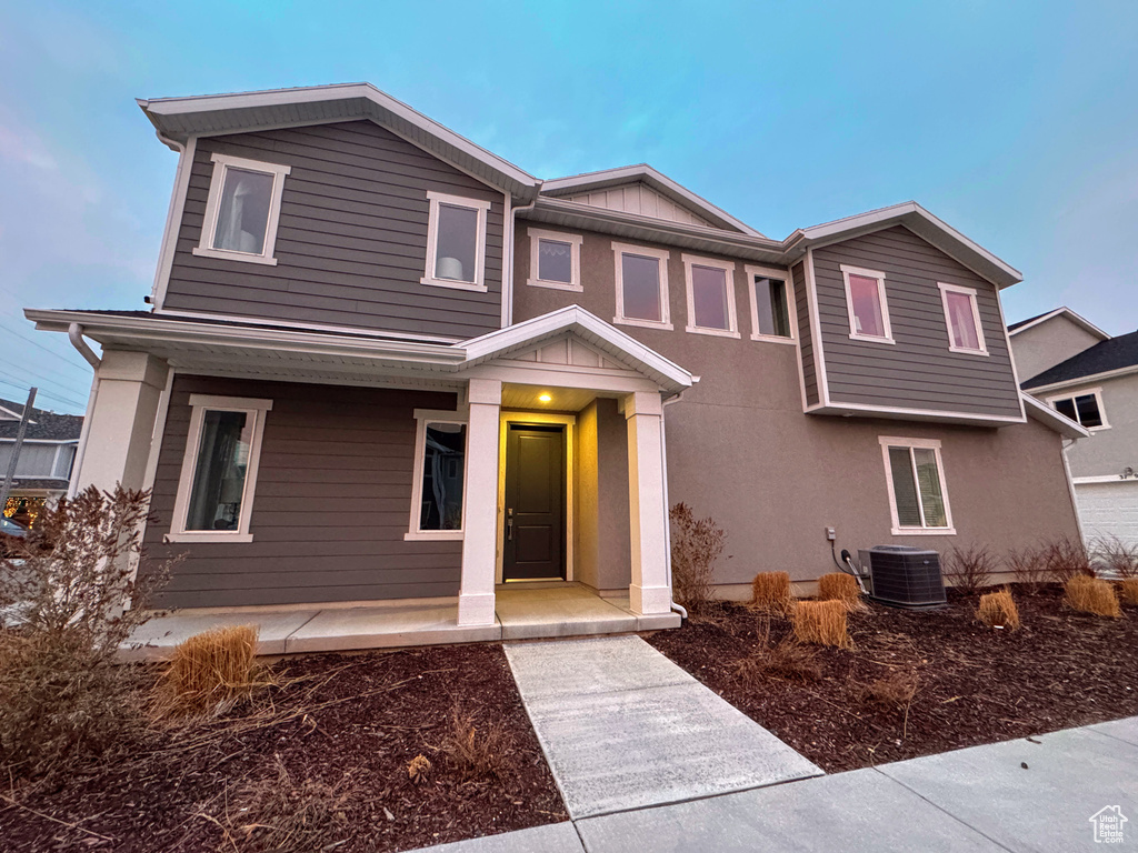 View of front of home featuring cooling unit