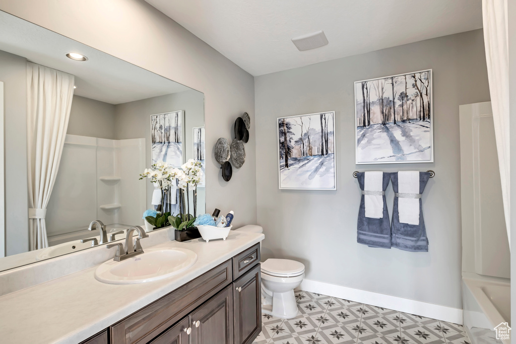 Full bathroom featuring vanity, shower / bathing tub combination, and toilet