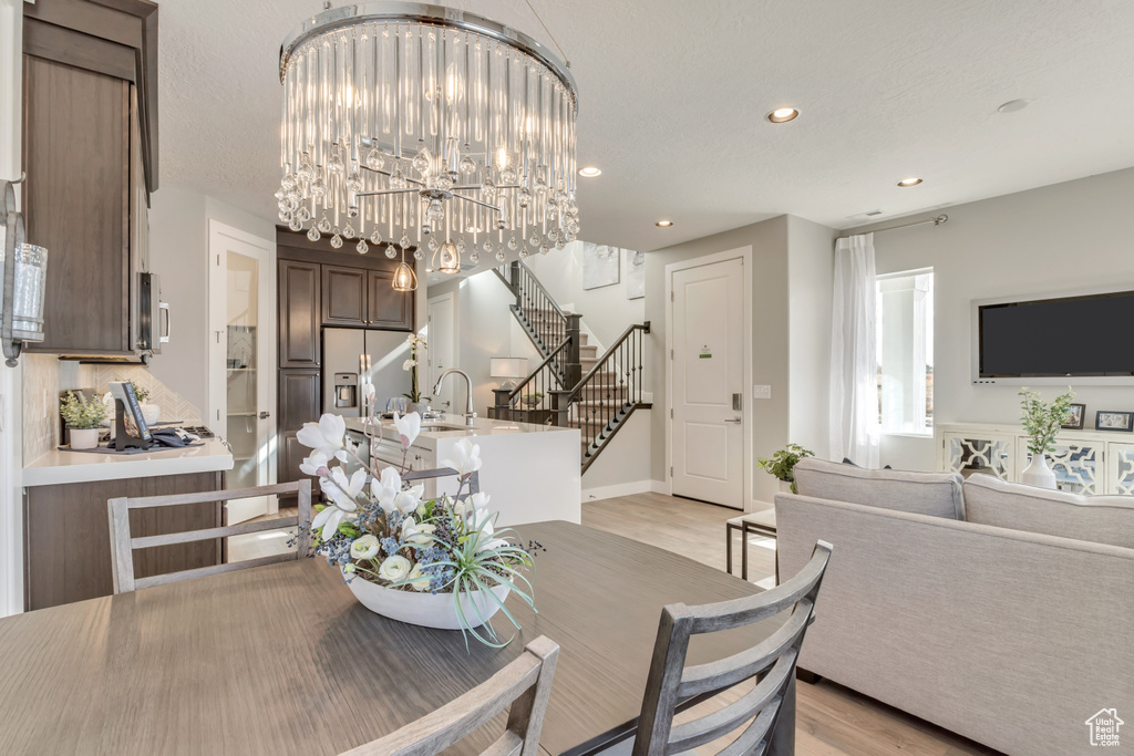 Dining space featuring a chandelier and light hardwood / wood-style floors