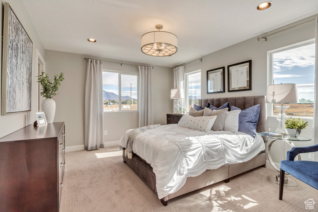 Bedroom with light colored carpet