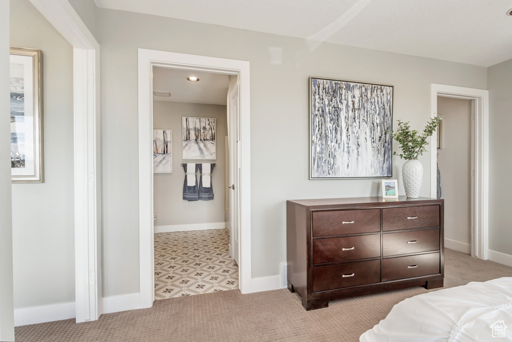 Bedroom featuring light carpet