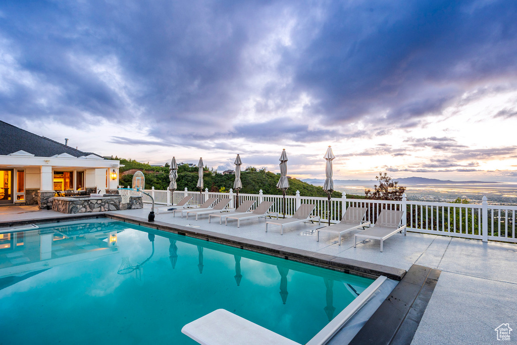 View of swimming pool with a patio area and fence