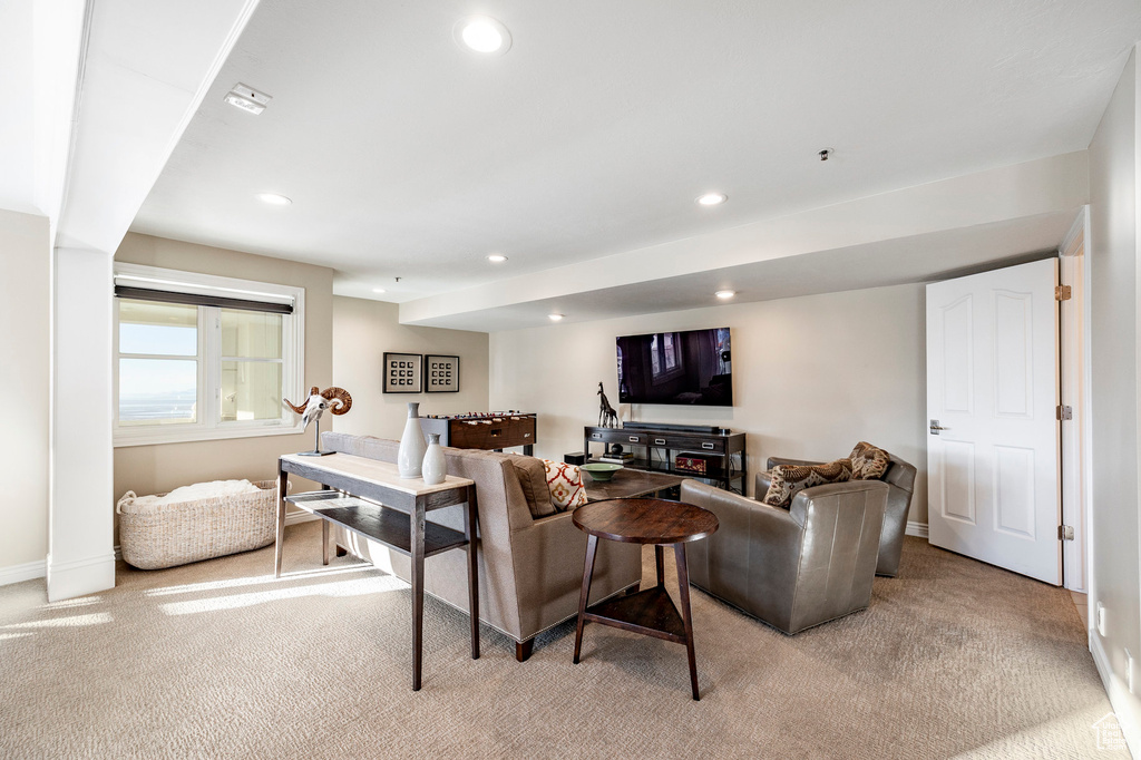 Living room featuring light colored carpet, recessed lighting, and baseboards