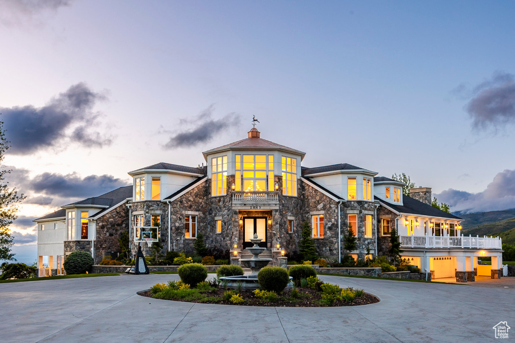 View of building exterior featuring curved driveway
