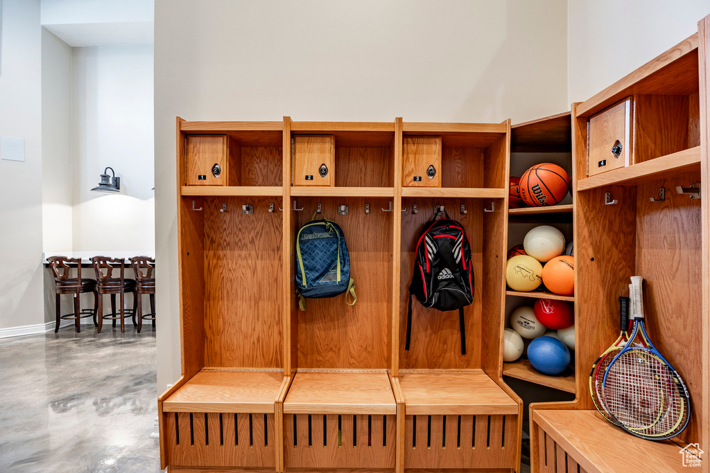 Mudroom with concrete flooring and baseboards