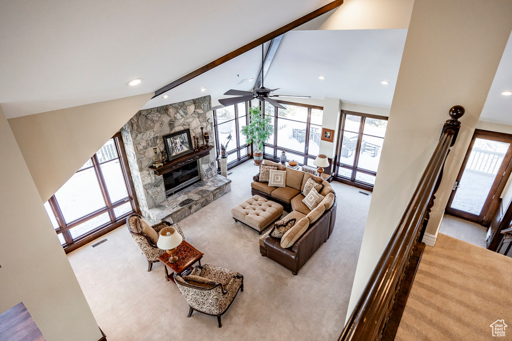 Carpeted living area featuring beam ceiling, a fireplace, recessed lighting, high vaulted ceiling, and ceiling fan