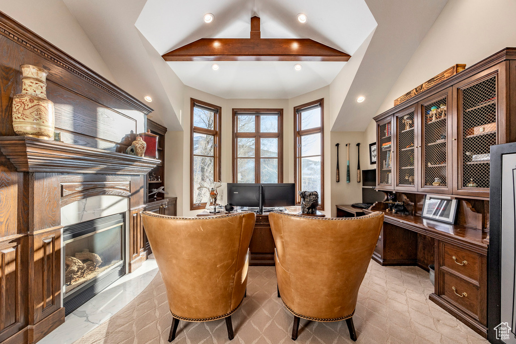 Office area featuring vaulted ceiling, recessed lighting, a premium fireplace, and built in study area