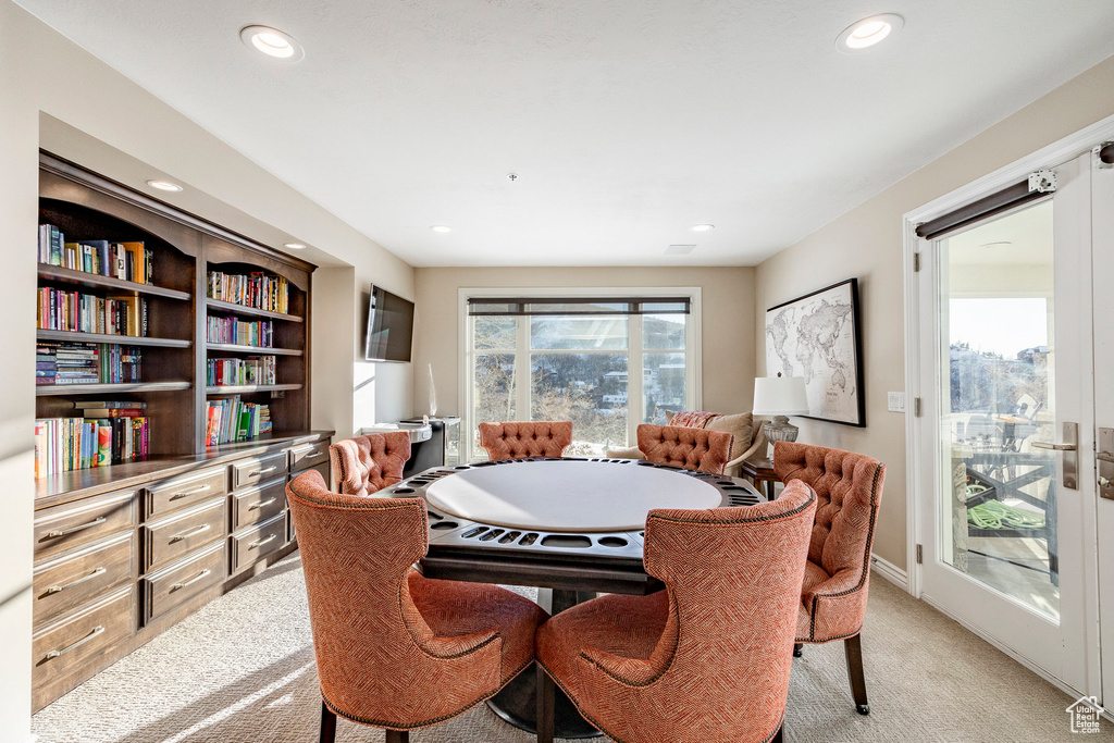 Dining space featuring light colored carpet, recessed lighting, an office area, and baseboards