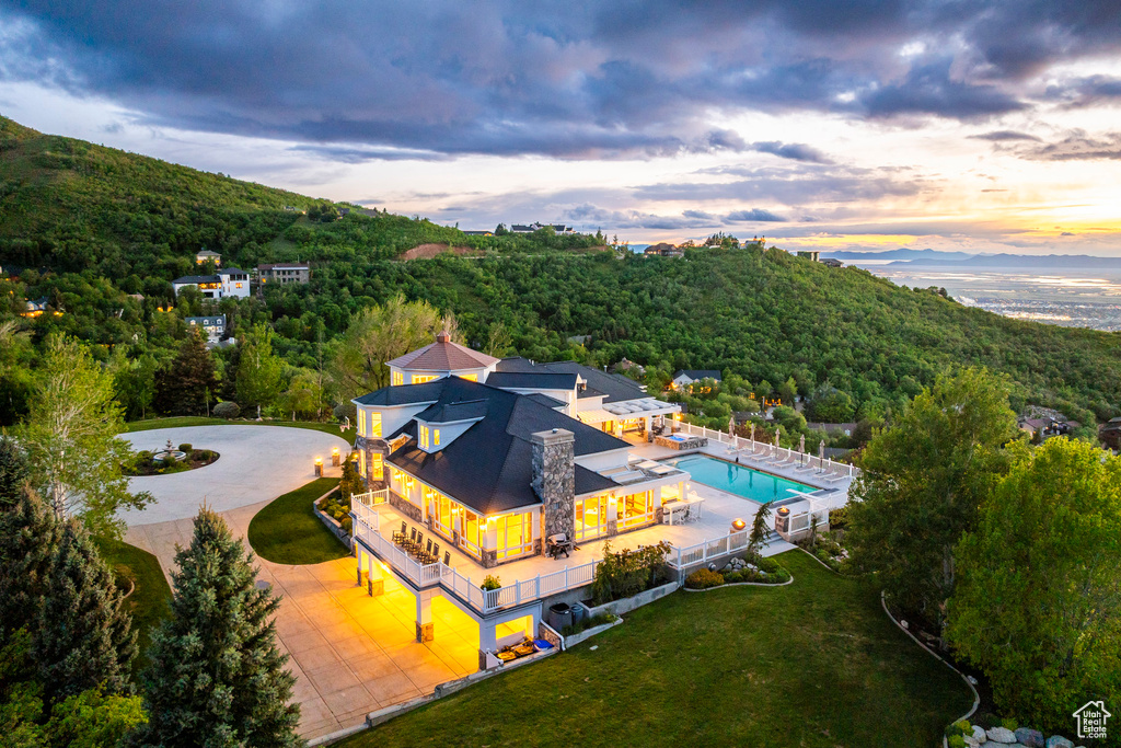 View of subject property featuring a forest and a pool