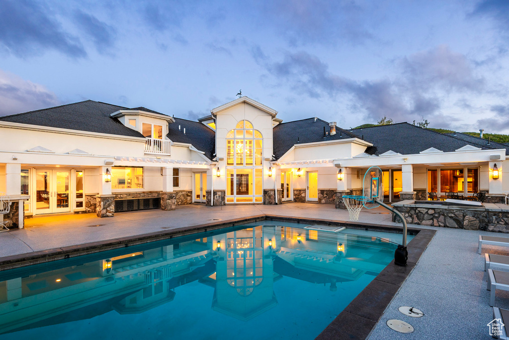 Swimming pool featuring french doors and a patio