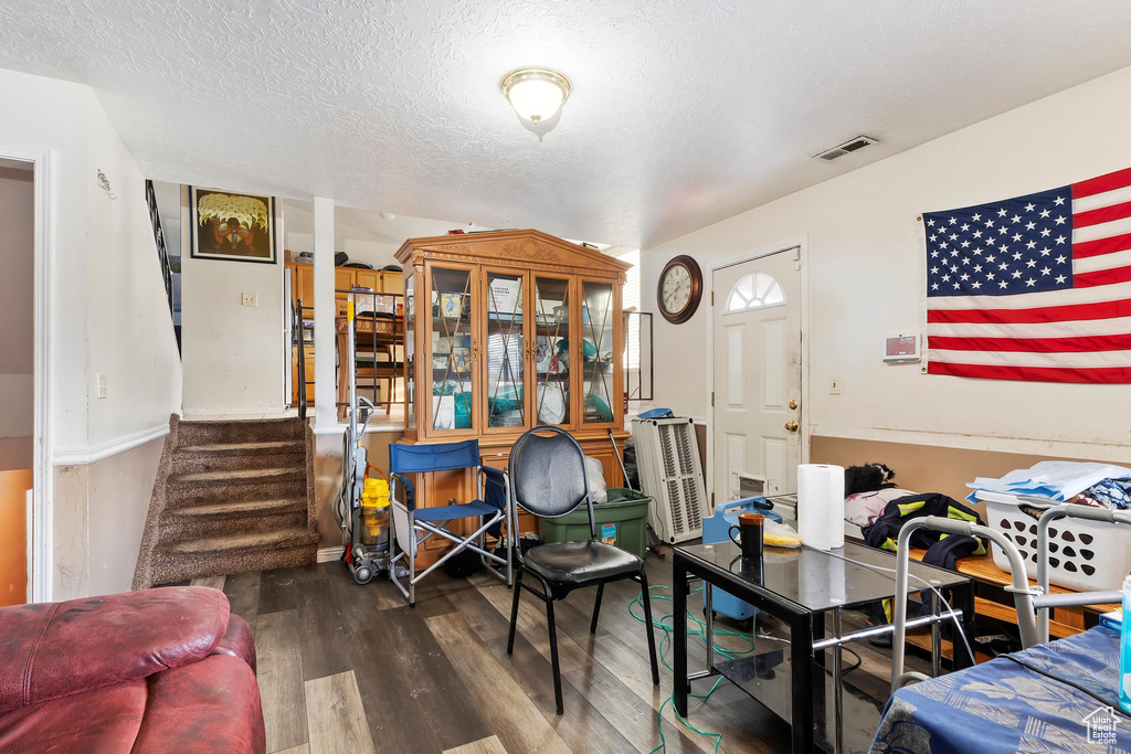 Interior space featuring a textured ceiling and hardwood / wood-style floors
