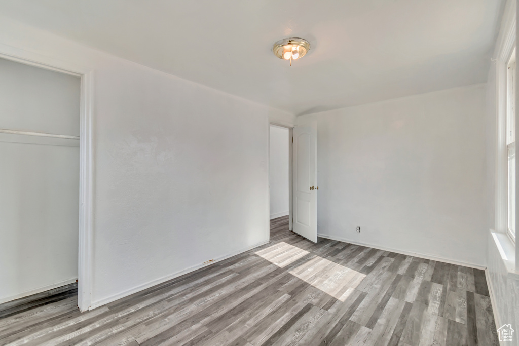 Unfurnished bedroom featuring light hardwood / wood-style flooring and a closet