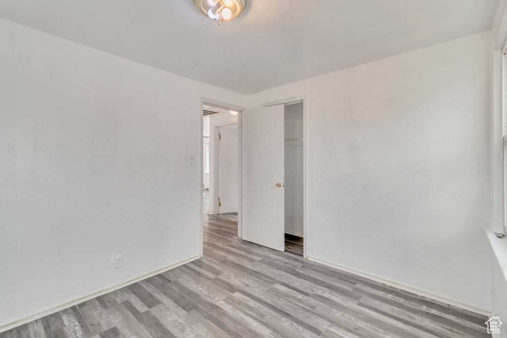 Empty room with light hardwood / wood-style flooring