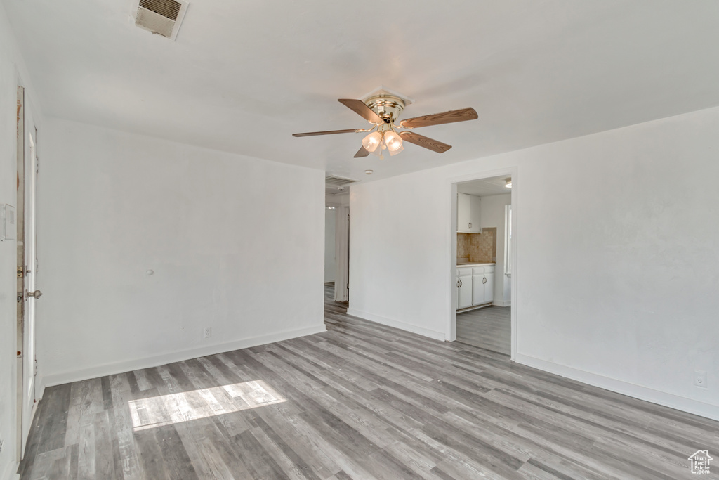 Interior space with ceiling fan and light hardwood / wood-style floors