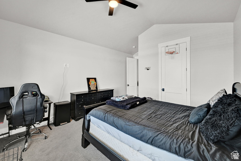Bedroom featuring ceiling fan, vaulted ceiling, and carpet floors