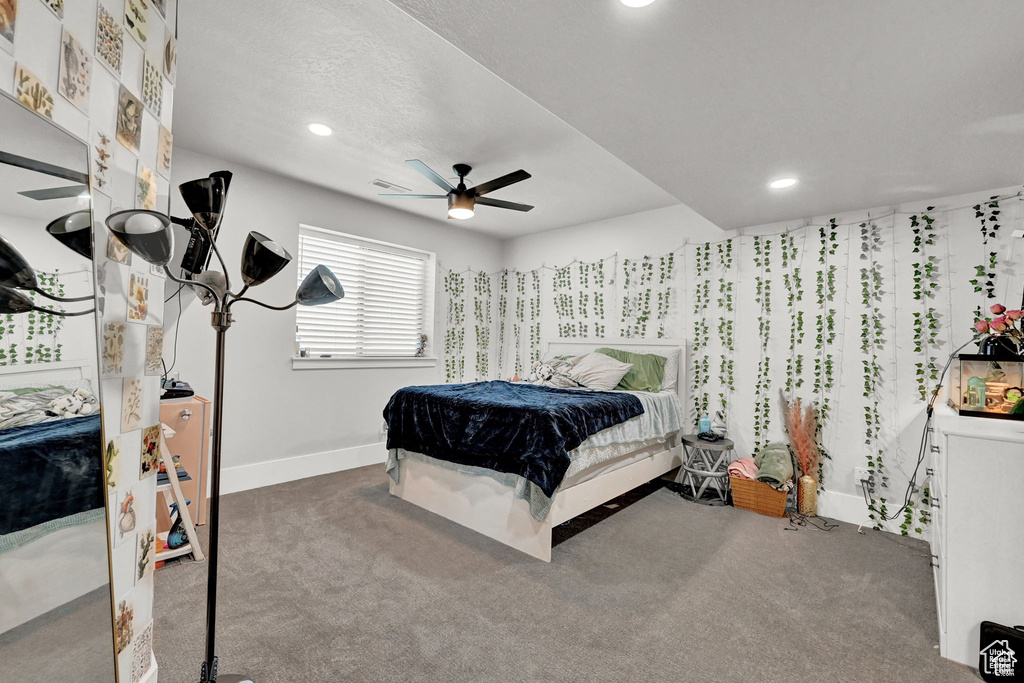 Carpeted bedroom with ceiling fan, baseboards, and recessed lighting