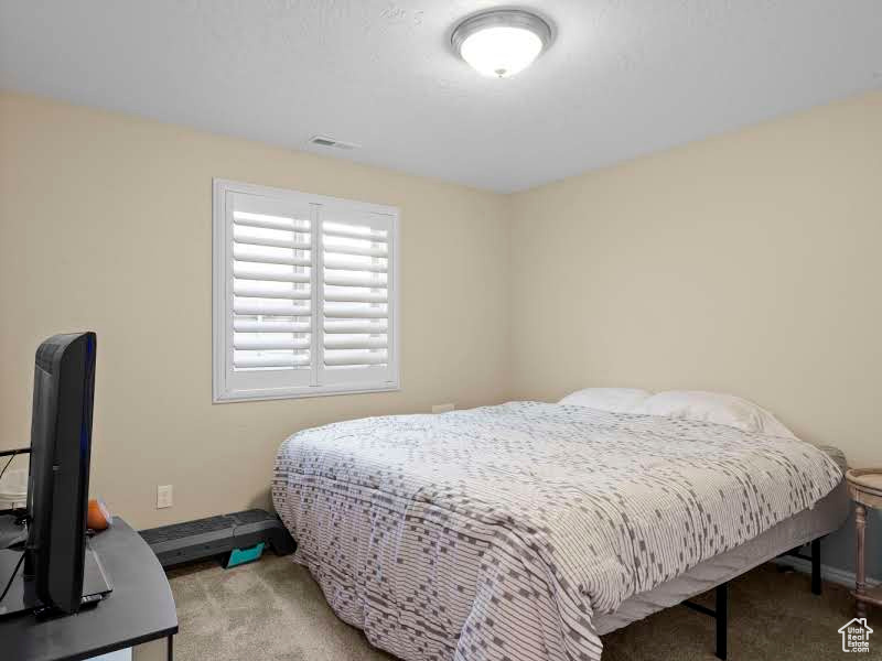 Bedroom with light colored carpet