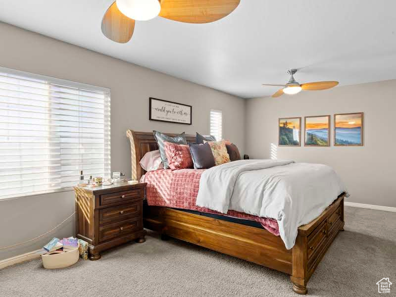 Bedroom with ceiling fan and carpet flooring