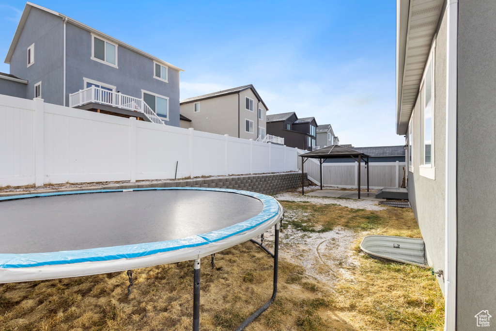 Exterior space featuring a trampoline and a gazebo
