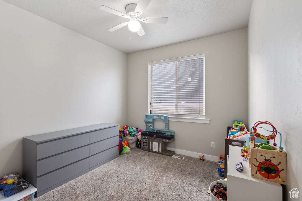 Recreation room featuring carpet floors and ceiling fan