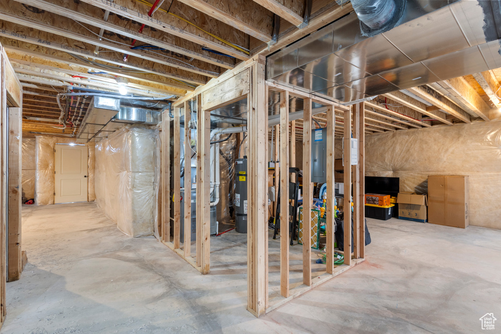 Basement with electric panel and electric water heater