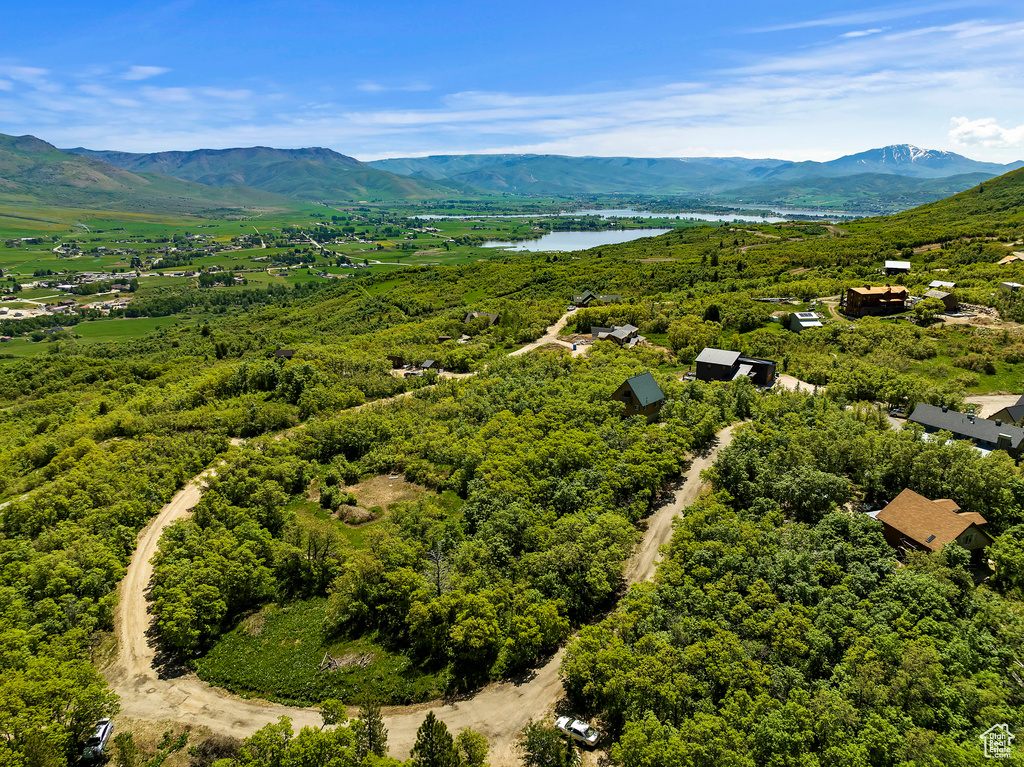 Drone / aerial view featuring a water and mountain view