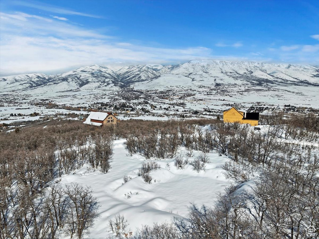 Snowy aerial view featuring a mountain view