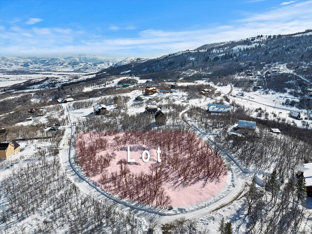 Snowy aerial view featuring a mountain view