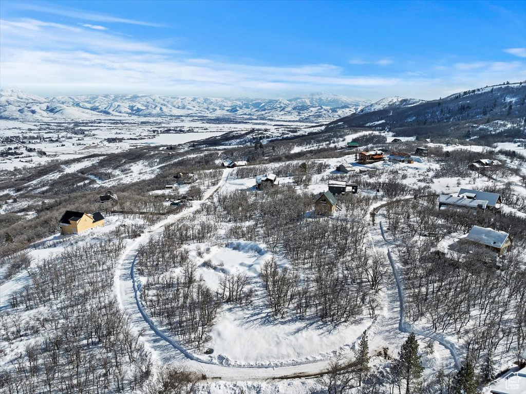 Snowy aerial view featuring a mountain view