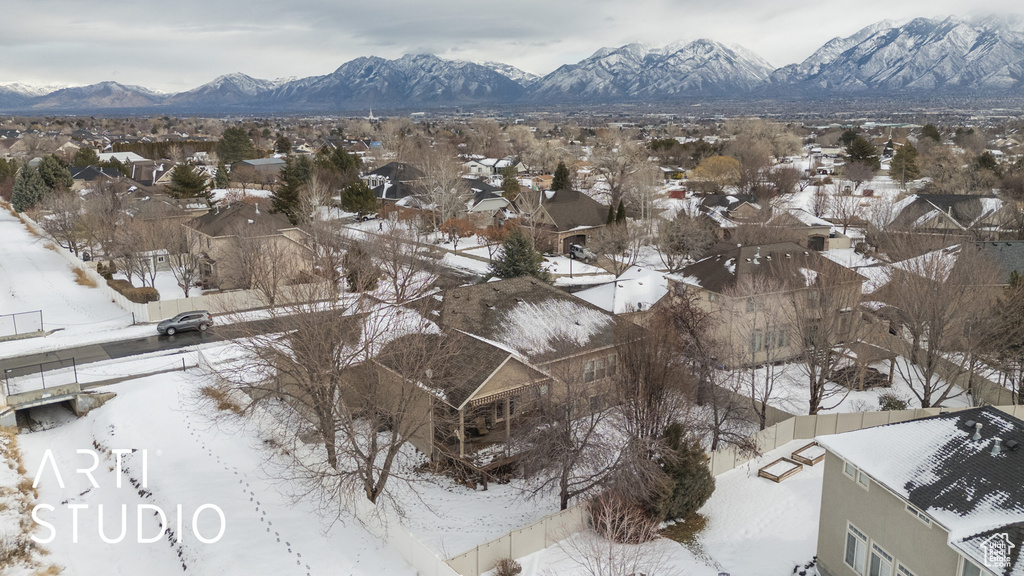 Snowy aerial view featuring a mountain view