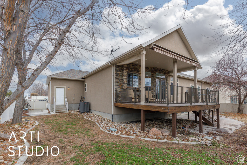 Back of property featuring a deck and cooling unit