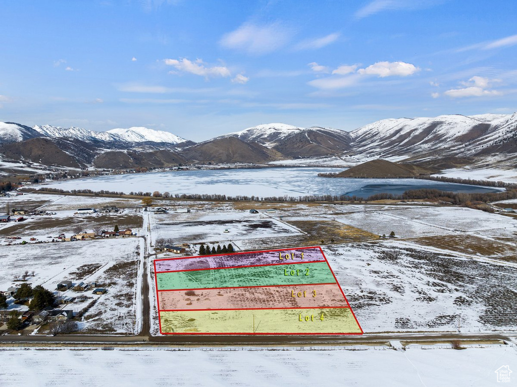 Snowy aerial view featuring property boundaries highlighted and a mountain view