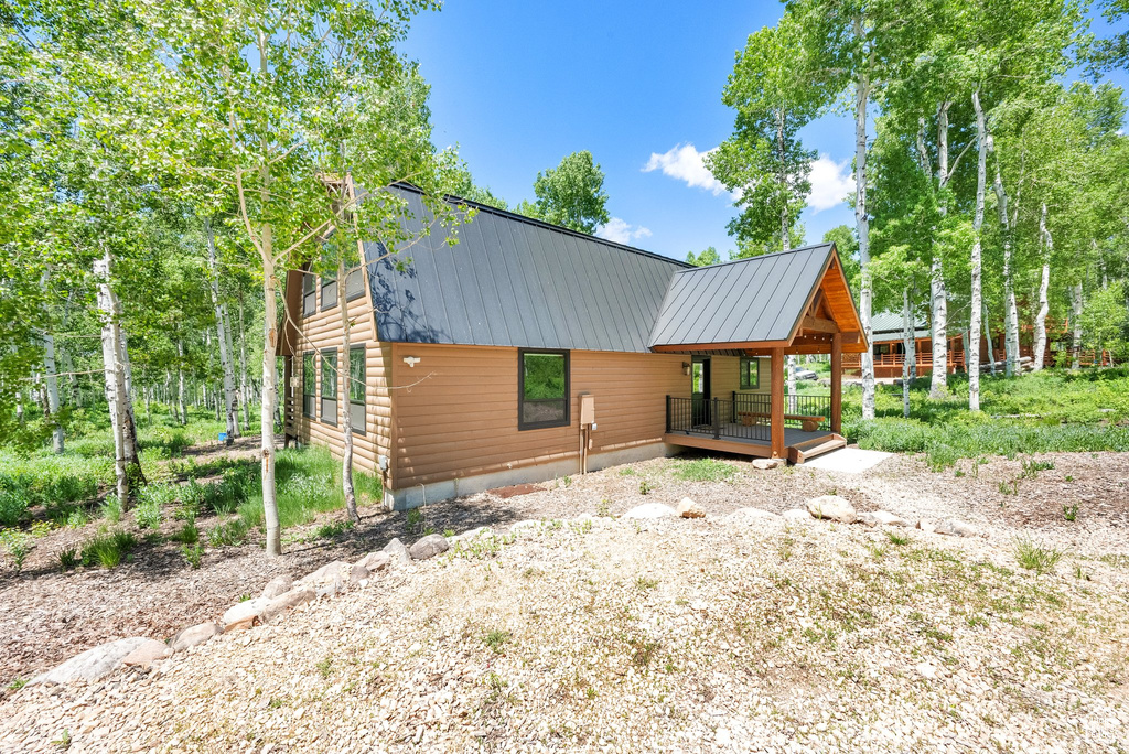 View of front of property with metal roof and log veneer siding