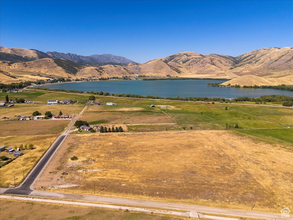 Birds eye view of property with a water and mountain view and a rural view