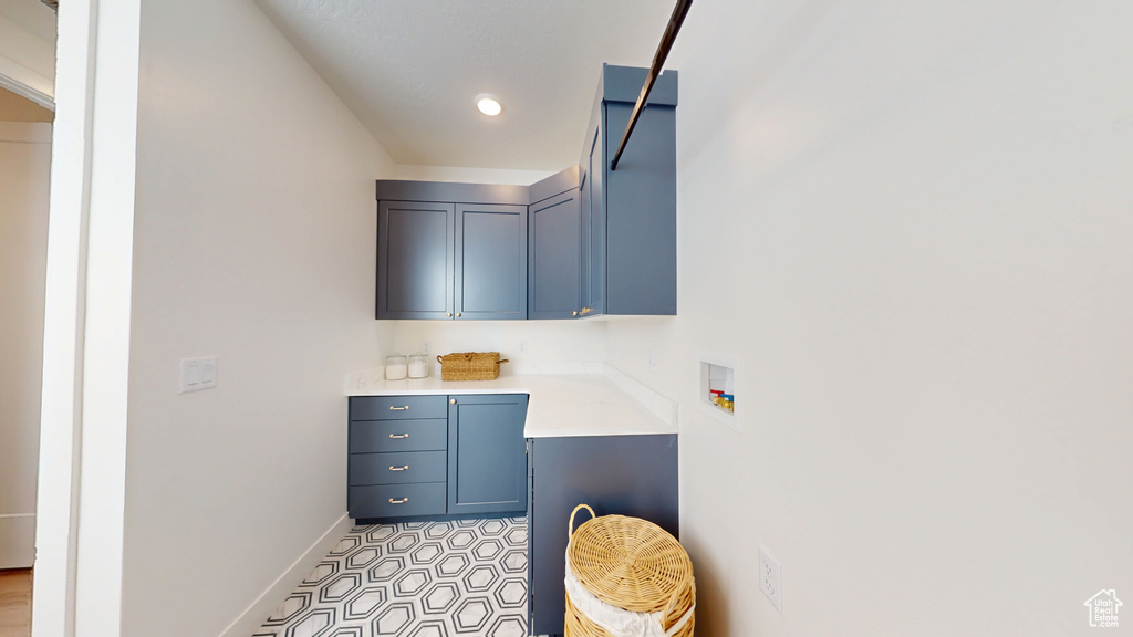 Interior space featuring cabinet space, baseboards, and washer hookup