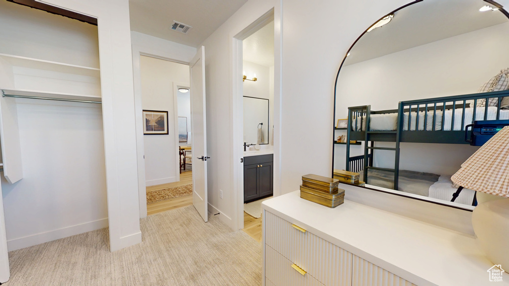 Bathroom with vanity, baseboards, and visible vents