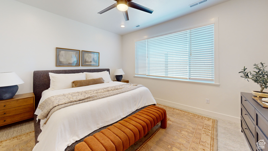 Bedroom with visible vents, baseboards, and a ceiling fan