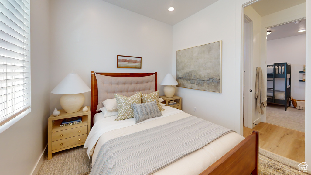 Bedroom with recessed lighting, wood finished floors, and baseboards