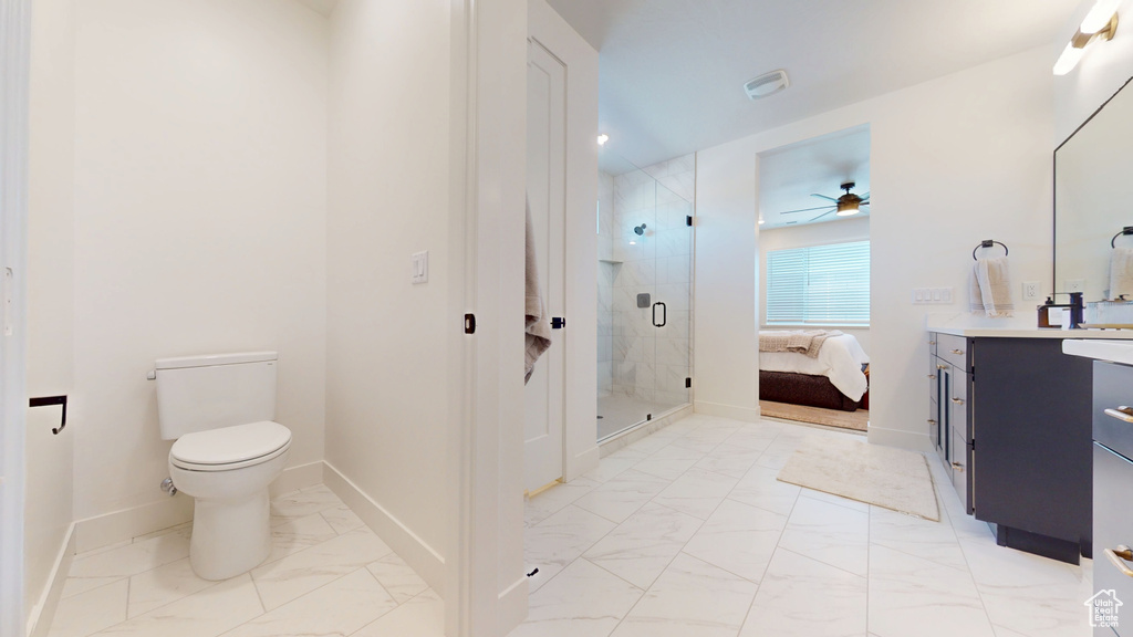 Ensuite bathroom with vanity, a ceiling fan, a shower stall, toilet, and marble finish floor