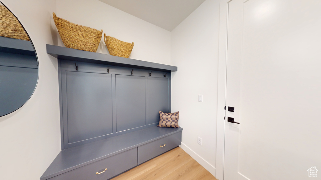 Mudroom with baseboards and light wood-type flooring