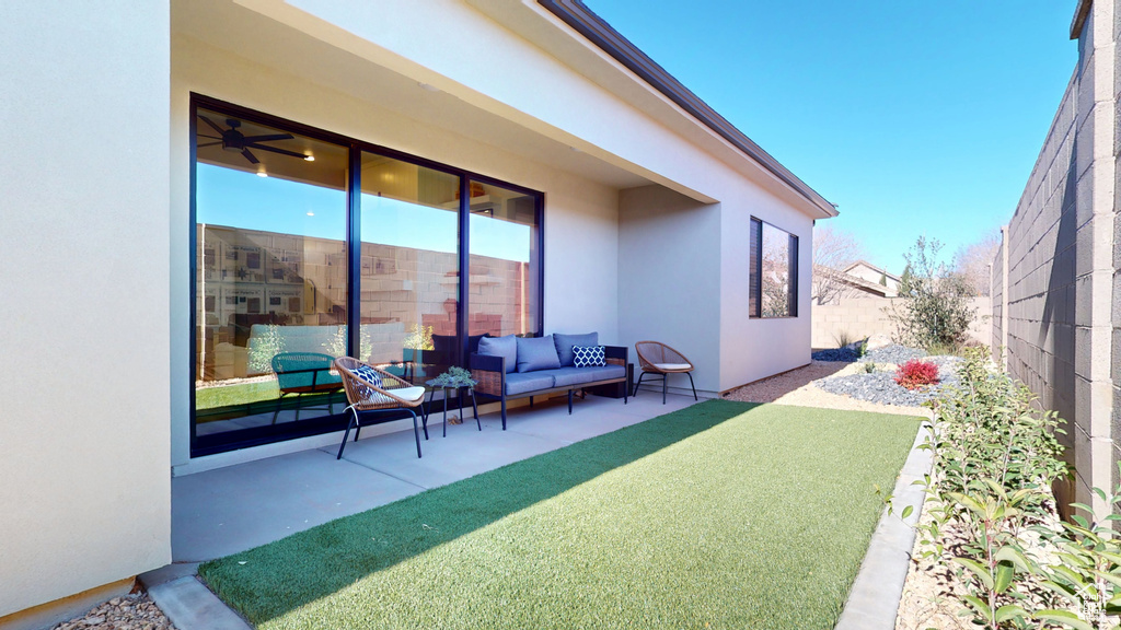 Exterior space with a fenced backyard and an outdoor hangout area