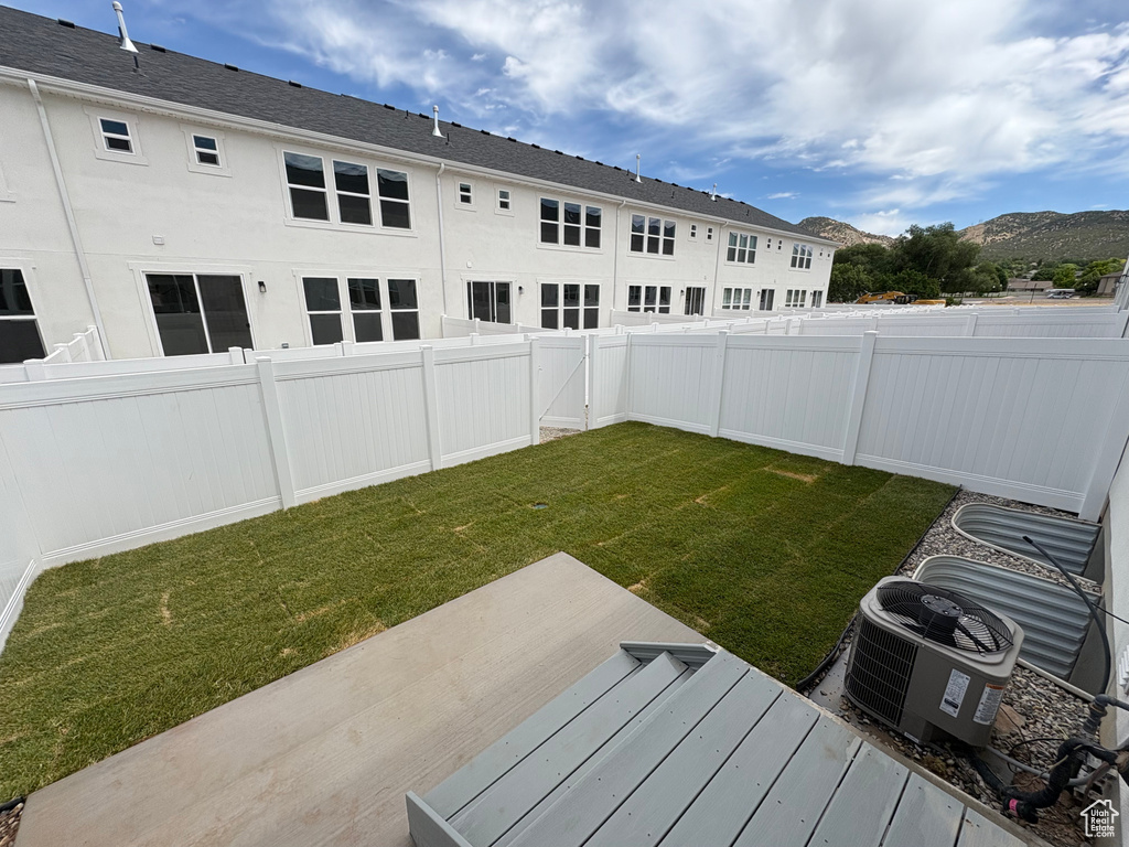 Fenced backyard featuring a mountain view