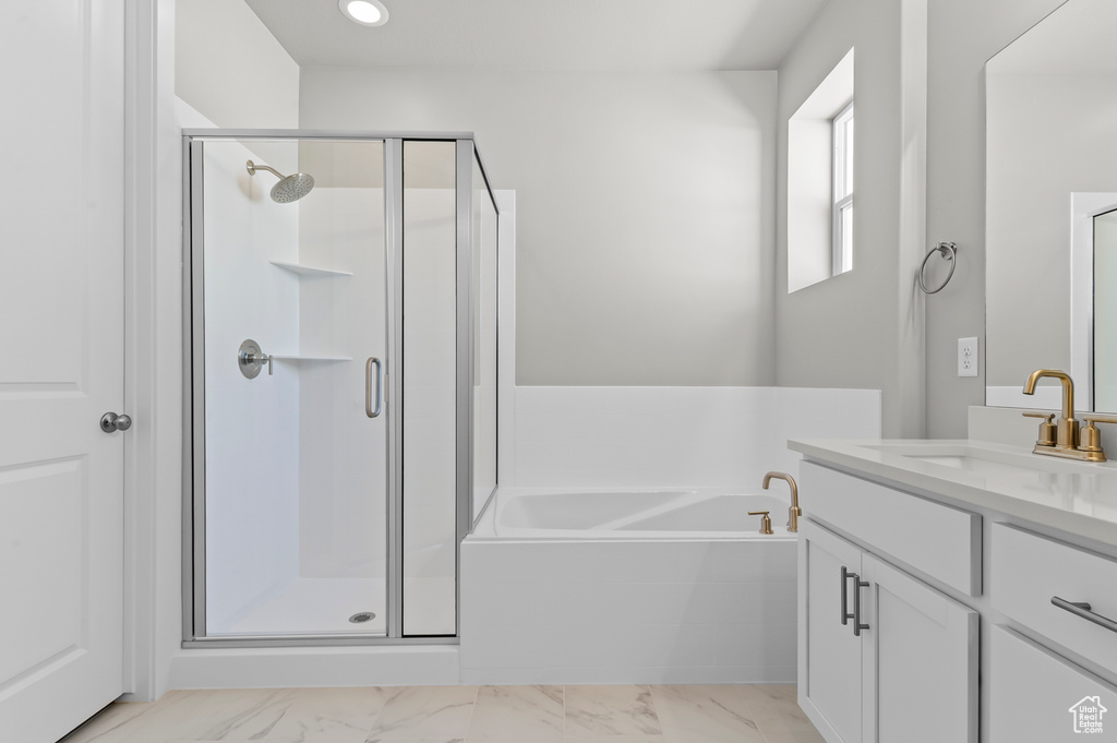 Full bath with vanity, a garden tub, a shower stall, and recessed lighting