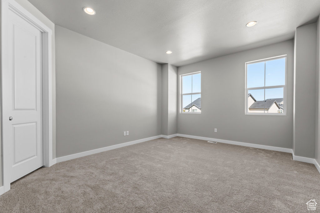 Spare room with carpet flooring, baseboards, and recessed lighting