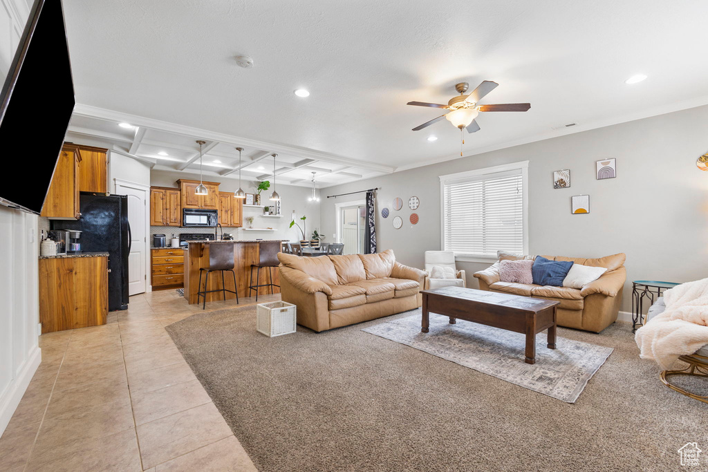 Living room featuring beam ceiling, light tile patterned floors, recessed lighting, ceiling fan, and coffered ceiling